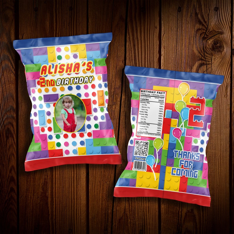 May include: A colorful chip bag with a Lego theme. The bag has a picture of a child and the text "Alisha's 2nd Birthday". The back of the bag has a nutritional label, a QR code, and the text "Thanks for coming".