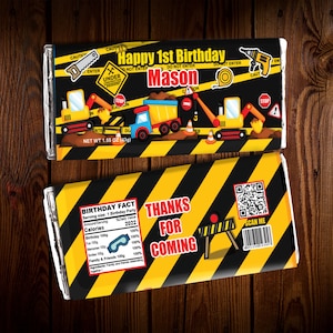 May include: Two chocolate bar wrappers with a construction theme. The top wrapper says "Happy 1st Birthday Mason" with construction vehicles. The bottom wrapper says "Thanks for Coming" and includes a QR code. The net weight is 1.55 oz (43g).