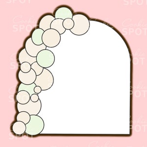 May include: A white cookie cutter shaped like an archway with a garland of pastel green and white circles on the left side.