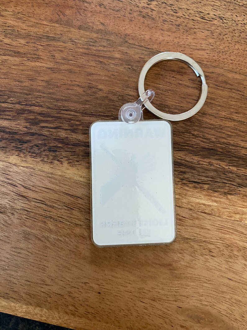 Peut inclure: Un porte-cl&eacute;s en plastique blanc avec un anneau en m&eacute;tal argent&eacute;. Le porte-cl&eacute;s est dot&eacute; d'un couvercle en plastique transparent avec un motif blanc de papillon &agrave; l'int&eacute;rieur. Le texte "Butterfly" est imprim&eacute; sur le porte-cl&eacute;s.