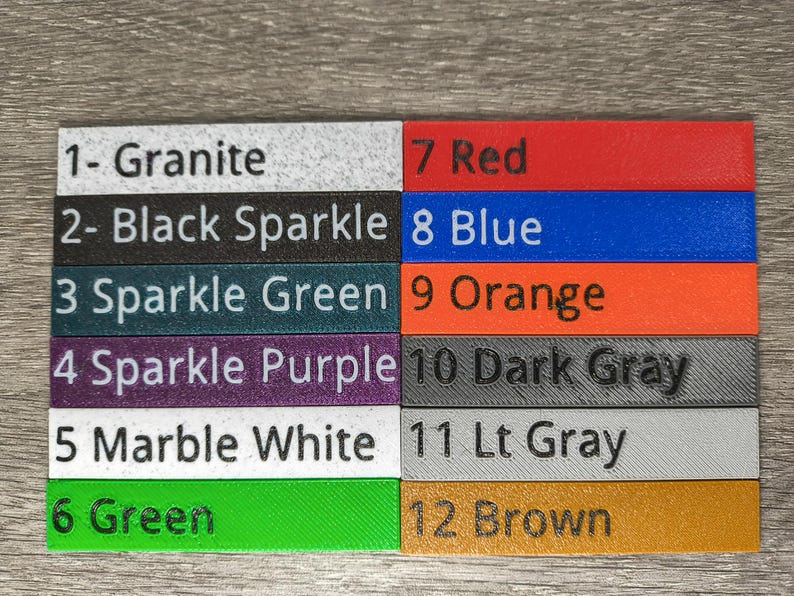 May include: A color swatch chart featuring twelve rectangular samples. The colors include Granite, Black Sparkle, Sparkle Green, Sparkle Purple, Marble White, Green, Red, Blue, Orange, Dark Gray, Lt Gray, and Brown. Each sample is labeled with a number and color name.
