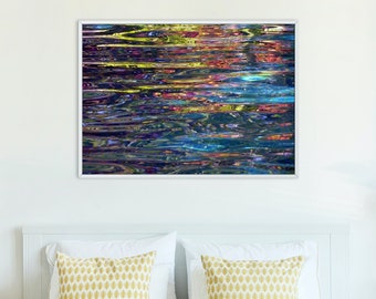 May include: A bedroom interior with a white bed, two yellow patterned pillows, a wooden bedside table with a lamp and flowers, and a framed abstract painting of colourful lines and shapes on the wall.