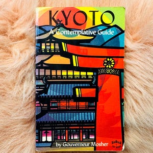 Puede incluir: Una colorida portada de libro titulada "KYOTO A Contemplative Guide" con una ilustración de arquitectura japonesa. La portada presenta tonos vibrantes de rojo, naranja, azul y amarillo. El nombre del autor, Gouverneur Mosher, está impreso en la parte inferior.