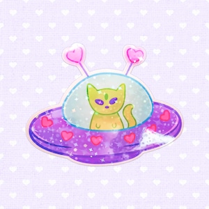 May include: A whimsical sticker featuring a cat alien in a purple UFO. The UFO has pink heart accents and antennae with heart-shaped tips. The cat is yellow-green with purple eyes, set against a light purple background with white hearts.