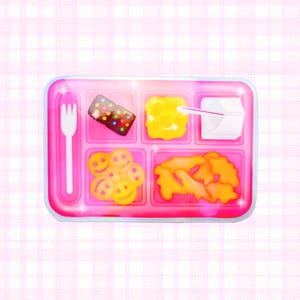 May include: A pink lunch tray with various food items. The tray includes a white fork, a chocolate dessert with colorful sprinkles, scrambled eggs, a small carton with a straw, smiley face cookies, and orange-colored fried food.