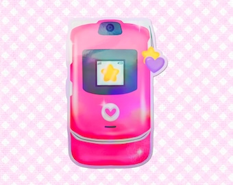 May include: A pink flip phone illustration with a star and heart charm. The phone has a screen displaying a star icon. The phone has a camera and a heart-shaped button. The background is a pink and white checkered pattern.