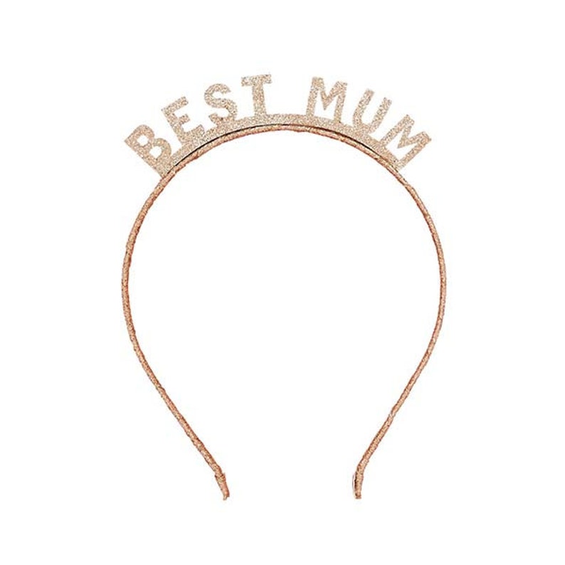 May include: A rose gold glitter headband with the words "BEST MUM" across the top. The headband is a thin, simple design, perfect for a special occasion or gift.