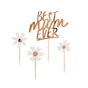 May include: A rose gold cake topper with the words "BEST MUM EVER" and four white daisy flower decorations. The cake topper and flowers are on thin gold stems, perfect for a Mother's Day celebration.