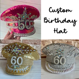 May include: Image of three custom birthday hats. One is hot pink with the number 50, another is gold with the number 60, and the third is silver with the number 60. Each hat is embellished with sequins and rhinestones. The text "Custom Birthday Hat" is also visible.