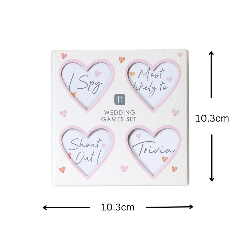 May include: A white square box with four pink heart-shaped frames. Each frame contains a wedding game idea: "I Spy", "Most Likely To", "Shout Out", and "Trivia". The box measures 10.3 inches by 10.3 inches.