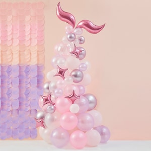 May include: A pink and white balloon arch with a pink mermaid tail on top. The arch is made of various sizes and textures of balloons, including some with a metallic finish.