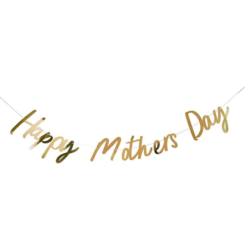 May include: A gold foil banner with the words "Happy Mothers Day" strung across a thin white string. The banner is in a cursive font and is set against a white background.
