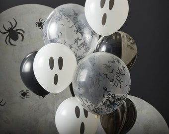 May include: A cluster of Halloween-themed balloons. White balloons with ghost faces and clear balloons filled with bat confetti are mixed with black balloons. The background features a gray moon and spider silhouettes.