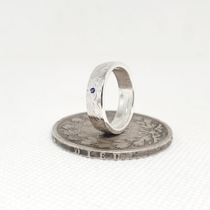 Louis Philippe 1 franc coin ring in silver wedding style set with a sapphire (ring corner)