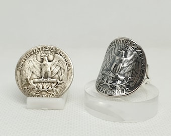 May include: Two silver rings made from US quarter dollar coins. The rings feature the image of the bald eagle on the coin. One ring is flat and the other is curved to fit a finger.