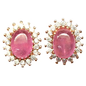 May include: A pair of pink gemstone earrings with a halo of small, clear gemstones.
