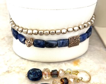 Delicate  stacking bracelet with deep blue “chiclet” beads with ornately carved brass beads