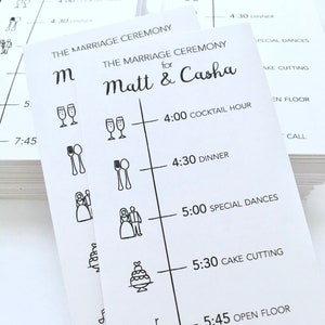 May include: A white wedding reception timeline card with black text and icons. The card lists the wedding reception events with times, including cocktail hour, dinner, special dances, cake cutting, open floor, and last call. The card is titled "The Marriage Ceremony for Matt & Casha".