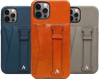 May include: Three leather phone cases with a built-in card holder and a strap. The cases are in blue, orange, and grey.