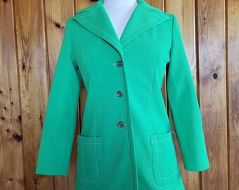 May include: A bright green blazer with white stitching. The blazer has a collar, four buttons, and two pockets.