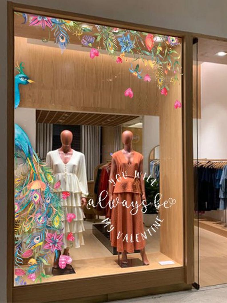 The Women's dress store, boutique storefront, showcase, watercolour print floral, flowers, paradise bird, peacocks, blue, pink, violet, purple fur.