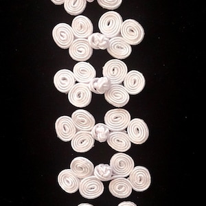 Set of six white frog fasteners