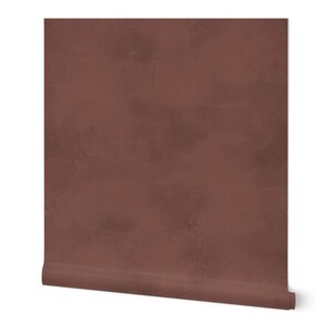 May include: A roll of textured wallpaper in a deep reddish-brown color. The wallpaper has a subtle, uneven texture that gives it a rustic look.