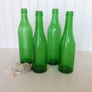 Lot of four green glass bottles Vintage green glass bottle decor  Glass bottle centerpiece Vintage glass bottles Antique bottles