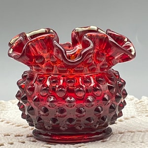 May include: A set of three ceramic mugs with a speckled, matte finish. The mugs are in shades of cream, light gray, and dark gray. Each mug has a simple, minimalist design, perfect for coffee or tea.