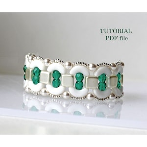 May include: A white and green beaded bracelet with a repeating pattern of white crescent shapes, silver beads, and green square beads. The bracelet is on a white surface. TUTORIAL PDF file.