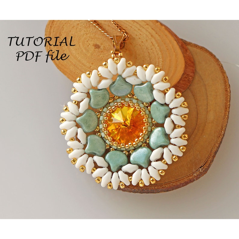 May include: A beaded pendant necklace with a round, multi-colored design. The pendant features a central yellow crystal surrounded by green and white beads. The necklace is made with gold-colored chain.