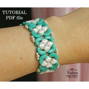 May include: A turquoise and white beaded bracelet with a geometric pattern. The bracelet is on a person's wrist. The image includes the text "TUTORIAL PDF file".