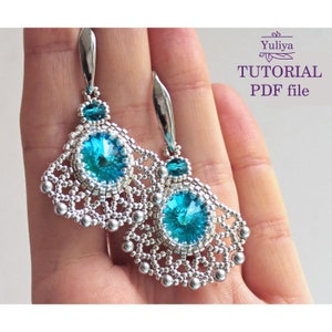 May include: A pair of silver earrings with a teal blue crystal and silver beads. The earrings are in the shape of a fan. The image includes the text "Yuliya TUTORIAL PDF file".