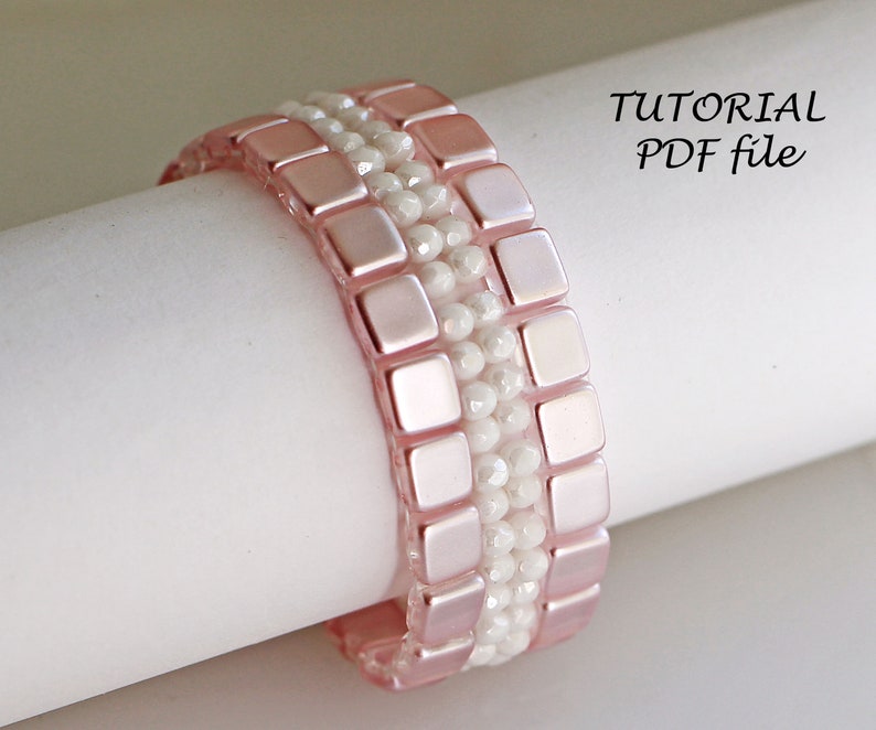 May include: A pink and white beaded bracelet with a square bead pattern.  The bracelet is on a white surface.  TUTORIAL PDF file.