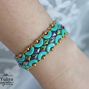 May include: A turquoise and gold beaded bracelet with a geometric pattern. The bracelet is made with small, round beads and larger, crescent-shaped beads.