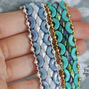 May include: Four beaded bracelets in shades of blue, turquoise, and gold. The bracelets are made with small, round beads and feature a variety of patterns.
