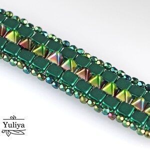 May include: A green and iridescent beaded bracelet with a geometric pattern. The bracelet features square and triangular beads.