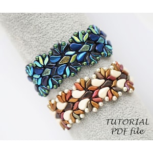 May include: Two beaded bracelets with a leaf and teardrop design. The top bracelet is blue, green, and gold. The bottom bracelet is white, brown, and gold. The bracelets are on a grey surface.  TUTORIAL PDF file.