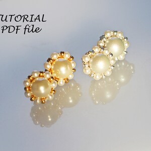 May include: Three pairs of pearl earrings with gold and silver bead accents. The earrings are on a white surface.  The text "TUTORIAL PDF file" is in the upper left corner of the image.