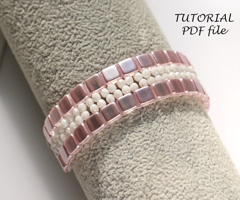 May include: A pink and white beaded bracelet with a square bead pattern. The bracelet is on a gray fabric surface. TUTORIAL PDF file.