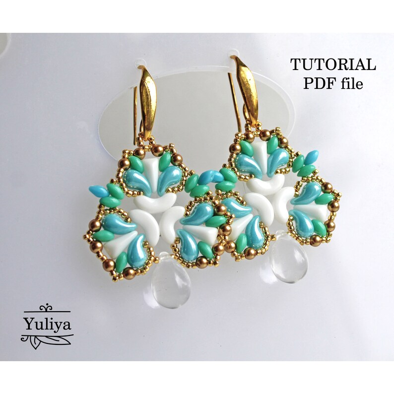 May include: A pair of gold earrings with a white and blue beaded design. The earrings are shaped like a flower with a teardrop-shaped crystal hanging from the bottom. The image includes the text "TUTORIAL PDF file".
