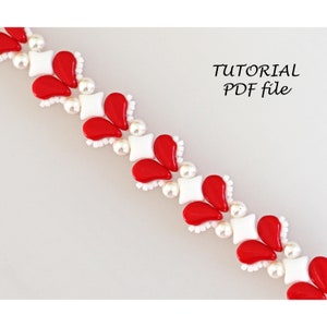 May include: A close-up of a red and white beaded bracelet. The bracelet is made with small, round beads and features a repeating pattern of red teardrop-shaped beads and white square beads.