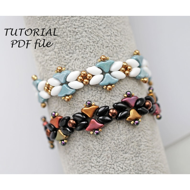 May include: Two beaded bracelets, one with white and blue beads and the other with black, red, and gold beads. The bracelets are on a grey surface.  "TUTORIAL PDF file" is written in black text at the top of the image.
