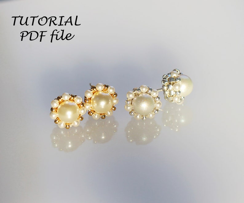 May include: Three pairs of pearl earrings, two with gold settings and one with silver settings. The earrings are all round and have a pearl in the center.