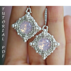 May include: A pair of silver and white beaded earrings with a pale pink gemstone in the centre of each earring.