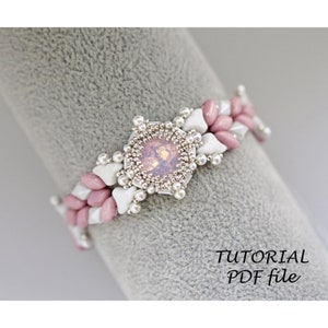 May include: A pink and white beaded bracelet with a large pink gemstone in the center. The bracelet is on a gray surface. TUTORIAL PDF file.