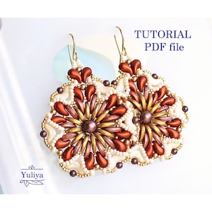 May include: A pair of beaded earrings with a gold, brown, and white color scheme. The earrings are in the shape of a flower with a pearl in the center. The image includes the text "TUTORIAL PDF file".