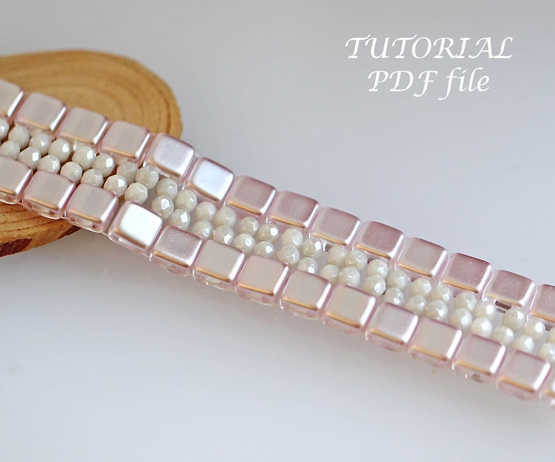 May include: A pink and white beaded bracelet with a square bead pattern. The bracelet is on a wooden surface. TUTORIAL PDF file.