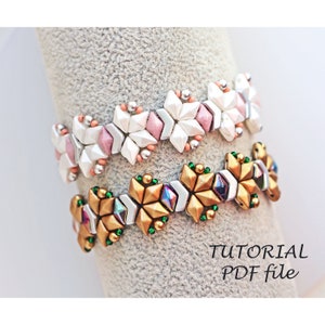 May include: Two beaded bracelets, one with white and pink beads and the other with gold and green beads. The bracelets are on a white surface with the text "TUTORIAL PDF file".