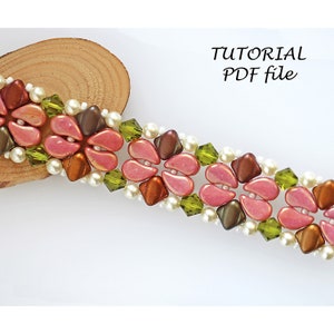 May include: A beaded bracelet with pink, brown, and green beads. The bracelet is made with seed beads and has a floral design. The image includes the text "TUTORIAL PDF file".